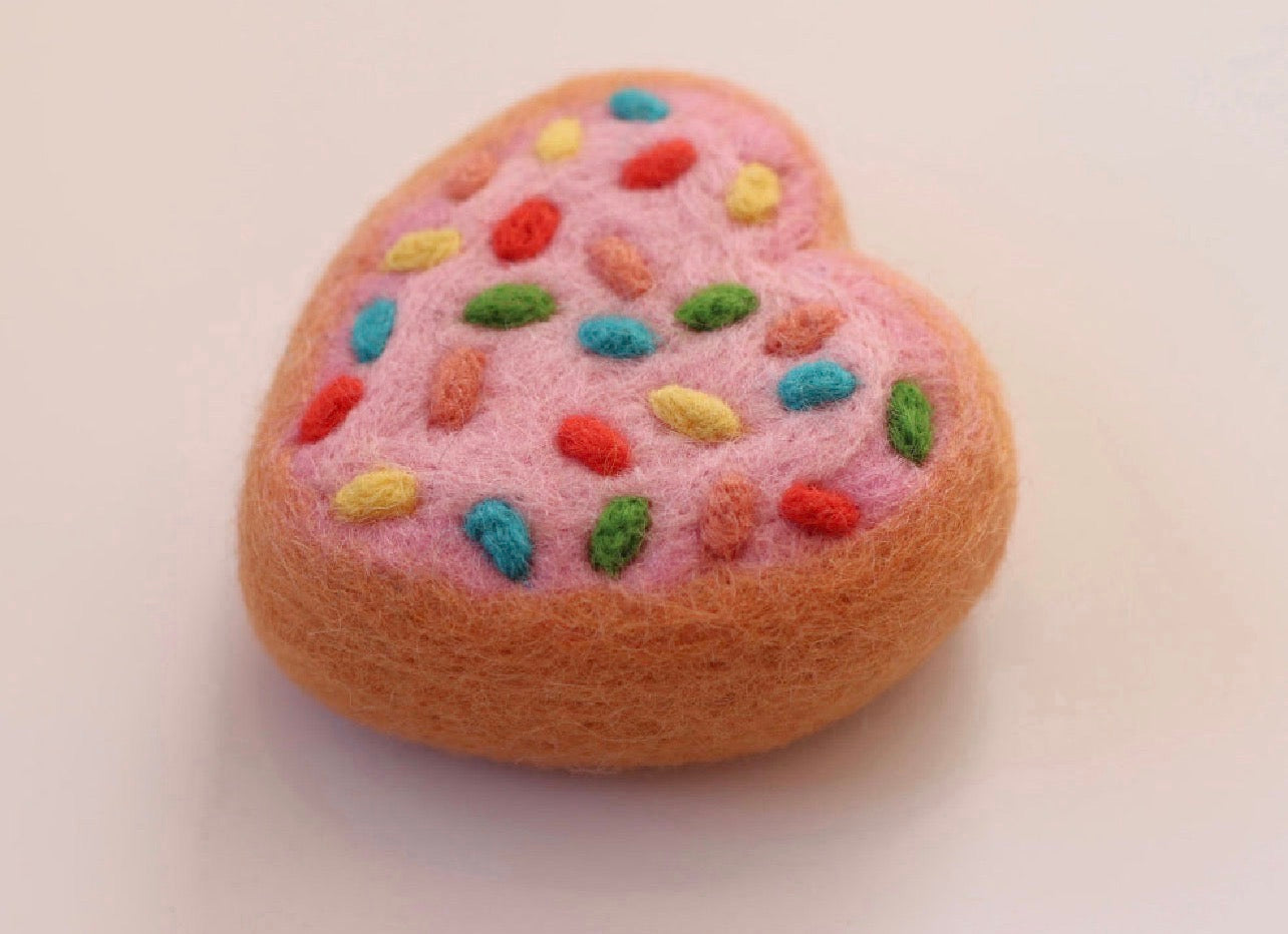 Pink love heart sprinkles donut